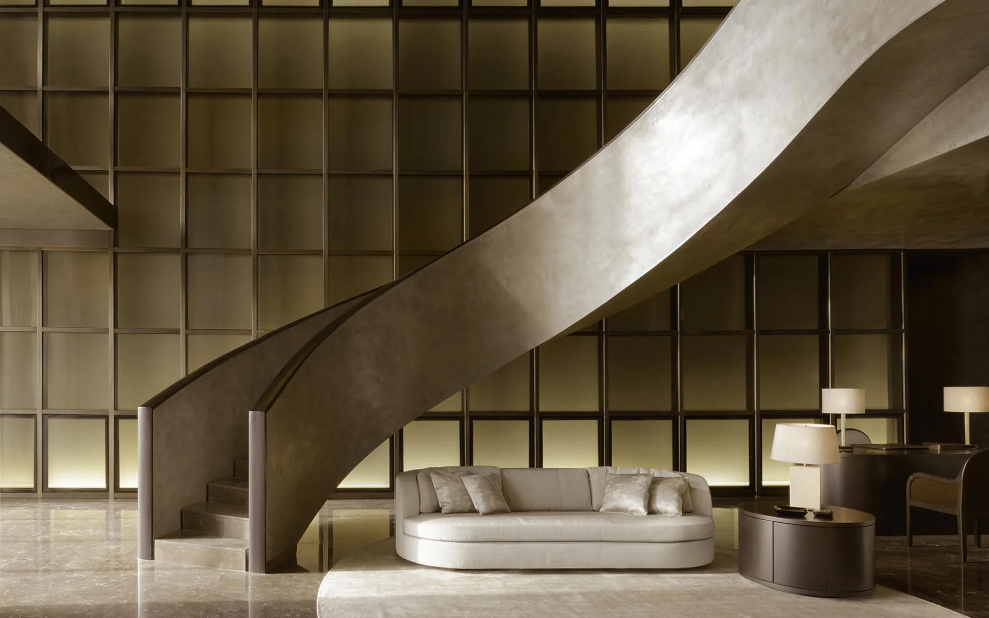 A sophisticated interior featuring an elegant curved staircase and a plush sofa, designed with a modern aesthetic that embodies the luxurious style of Armani, enhanced by warm lighting and refined materials.