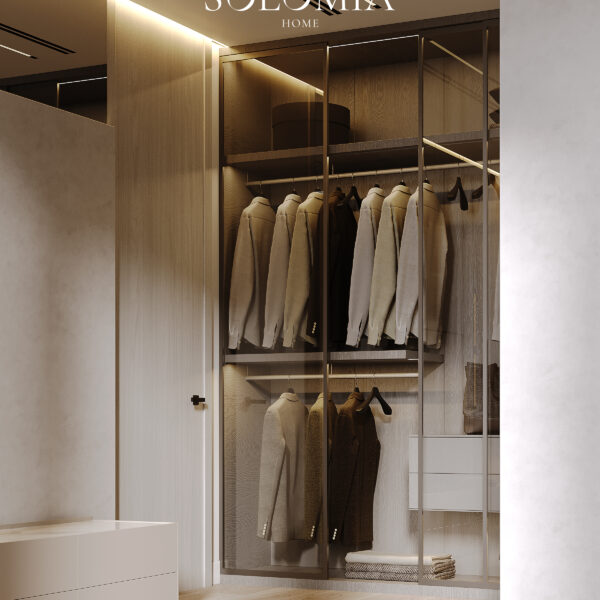 Modern bedroom with a glass-front wardrobe displaying neatly organized clothes and soft lighting